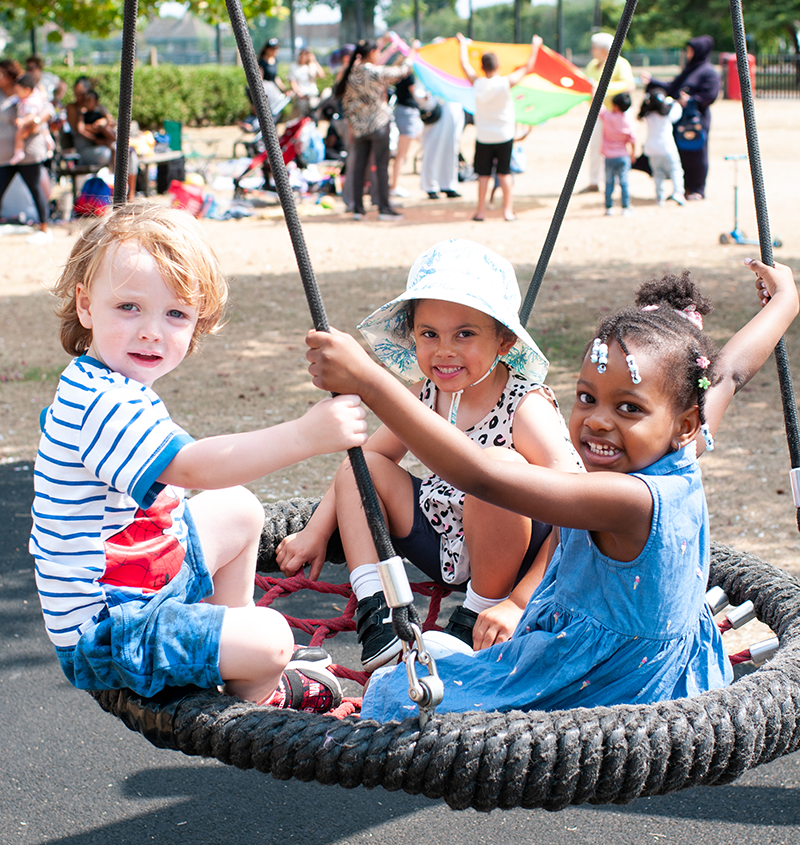 St Chads Preschool students playing on a swing